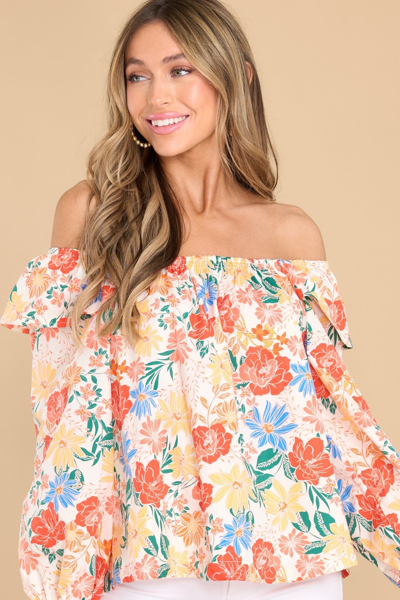 Front view of this top that features a stretchy scoop neckline, an optional off-the shoulder style, ruffle detailing in the shoulders, and long sleeves with elastic cuffs.