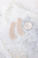 Gold rhinestone earrings compared to quarter for actual size. Earrings measure approximately 2