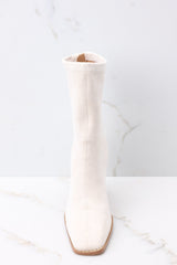Front view of ivory high heel booties with a soft suede texture throughout. 