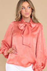 Front view of this top that features flowy balloon sleeves with two buttons at the cuff.