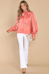 Full body view of this top that features flowy balloon sleeves with two buttons at the cuff and a relaxed fit.