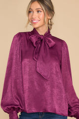 Front view of this top that features a high neckline with an adjustable self tie.