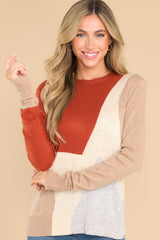 Front view of this sweater that features a crew neckline, ribbed cuffs and hem, a multi-colored geometric pattern, and a soft knit material.