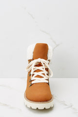 Front view of these boots that feature faux fur around the ankle, a chunky sole and laces up the front.