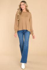 Full body view of this top that features a round neckline and subtle bubble sleeves.