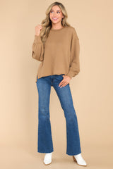 Full body view of this top that features a round neckline, subtle bubble sleeves, a bottom hem that is approximately 2