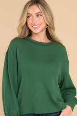 Front view of  this top that features a round neckline, subtle bubble sleeves, a bottom hem that is approximately 2