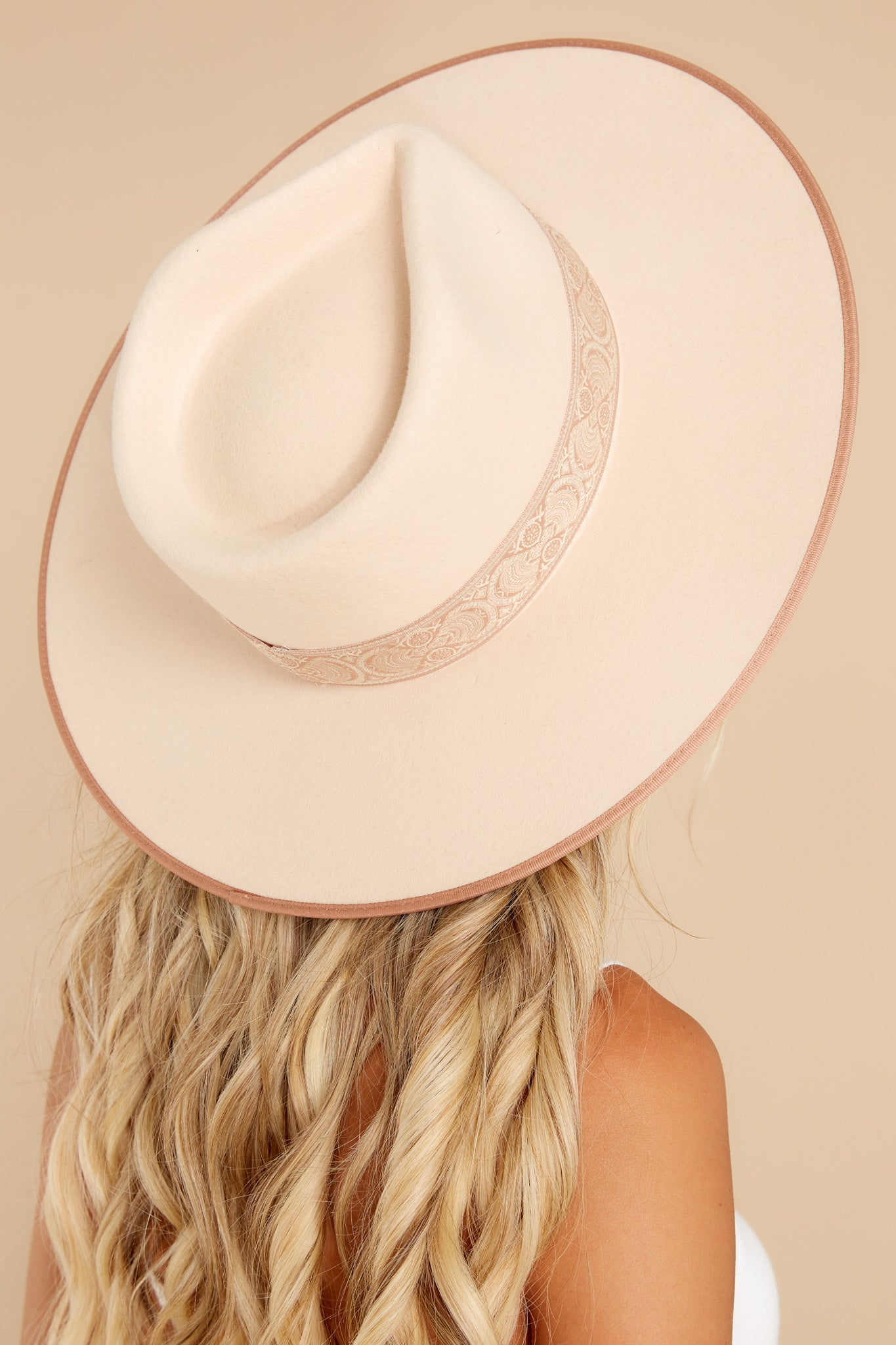 Angled back view of this hat that is featuring a stiffened wool fedora with a rigid crown design, and trimmed with a tonal grosgrain ribbon.