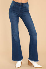 Front view of these jeans that feature a high waist, classic button zipper closure and flared leg.