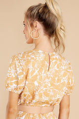 Back view of  this top that features a cropped fit, puff sleeves, and scrunched waist with an adjustable tie.