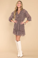 Full body view of this dress that features a v-neckline with a self-tie closure, long sleeves with elastic cuffs, a smocked waistband, and a flowy skirt.
