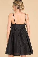 Back view of this dress that features a sweetheart neckline with a key hole detail on the bust, the bow at the bust is non-adjustable, adjustable spaghetti straps, zipper on the back, and a babydoll silhouette.