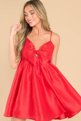 Front view of this dress that features a sweetheart neckline with a key hole detail on the bust, the bow at the bust is non-adjustable, adjustable spaghetti straps, zipper on the back, and a babydoll silhouette. 