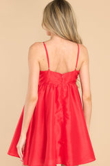 Back view of this dress that features a sweetheart neckline with a key hole detail on the bust, the bow at the bust is non-adjustable, adjustable spaghetti straps, zipper on the back, and a babydoll silhouette. 