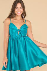 Front view of this dress that features a sweetheart neckline with a keyhole detail on the bust, the bow at the bust is non-adjustable, adjustable spaghetti straps, zipper on the back, and a babydoll silhouette.