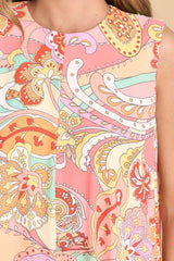Close up view of this dress that features a high round neckline and a sleeveless design.