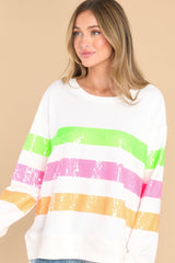 Front view of this top that features a sequin design across the body in shades of green, pink, and orange.