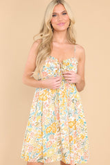 Front view of this dress that features a sweetheart neckline, adjustable straps, a self-tie at the bust, a smocked insert at the back of the bust, side pockets, and a flowy skirt.
