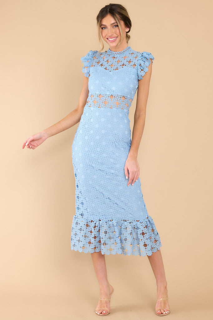 This light blue crochet lace midi dress features a high neckline with an illusion sweetheart neckline, ruffled shoulders, a peek-a-boo waistline which gives way into a sheath silhouette fit, and a flounced hem. 
