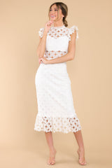 Full body view of this crochet lace midi dress that features a high neckline with an illusion sweetheart neckline, ruffled shoulders, a peek-a-boo waistline which gives way into a sheath silhouette fit, and a flounced hem.