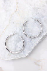 Overhead view of hoops that feature a silver design and a post-back closure.