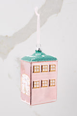 Angled back view of this ornament that features a building that says 