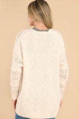 Back view of  this cardigan that features a textured design, ribbed detailing, and a soft fabric.