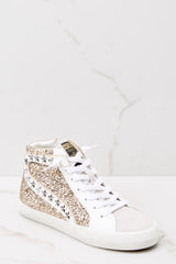 Outer-side view of these sneakers that feature a glittered body with star studs along the side, standard lace-up front, white laces, textile interior, a glitter base and side zipper.