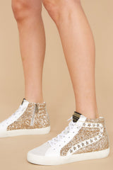 These gold and grey sneakers feature a glittered body with star studs along the side, standard lace-up front, white laces, textile interior, a glitter base and side zipper.