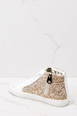 Inner-side view of these sneakers that feature a glittered body with star studs along the side, standard lace-up front, white laces, textile interior, a glitter base and side zipper.