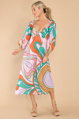 This multi-colored dress features a sweetheart neckline with a self tie between the bust, a smocked stretched insert on the back, puff sleeves with elastic around the shoulders and cuffs, and a flowy body.