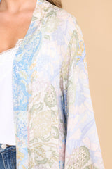Close up view of this coverup that features an intended wide and flowy fit, and a sheer lightweight fabric.