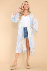 Full body view of this coverup that features an intended wide and flowy fit, and a sheer lightweight fabric.