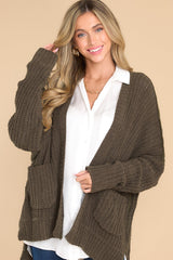 Front view of this cardigan that features a soft, chunky knit design, functional pockets, and small slits up the sides.