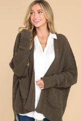 Front view of this cardigan that features a soft, chunky knit design, and functional pockets.