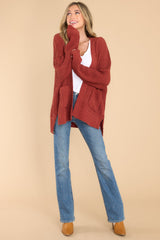 Full body view of this cardigan that features a soft, chunky knit design, and functional pockets.