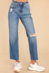 Front view of these jeans that feature a high waist, a zipper-button closure, functional belt loops and pockets, minimal distressing, and a raw hemline.