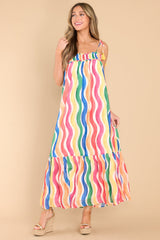 This rainbow stripe dress features a square neckline, adjustable tie shoulder straps, elastic band around the chest, a cut out on the back, and a flowy silhouette. 