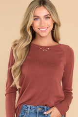 Front view of this top that features a round neckline and ribbed detailing along the hem and cuffs.