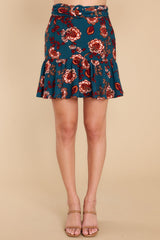 Front view of this mini skirt that features a high-waisted fit, a belt detail around the waist, and a flowy hem.