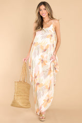 Full body view of this dress that showcases the floral pattern of the ivory fabric.