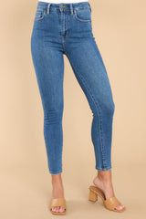 These medium wash skinny jeans feature a high waisted fit, functional front and back pockets, and a relaxed fit around the ankles.