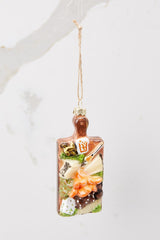 This multi-colored ornament features a cheese platter design with details of green and orange.