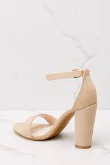 Inner-side view of these heels that feature an adjustable ankle strap, thick block heel, and a toe strap.