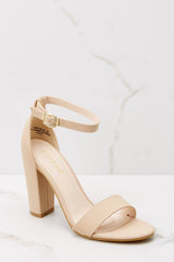 Close up view of these heels that feature an adjustable ankle strap, thick block heel, and a toe strap.