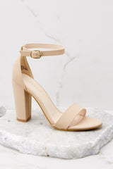 Outer-side view of these heels that feature an adjustable ankle strap, thick block heel, and a toe strap.