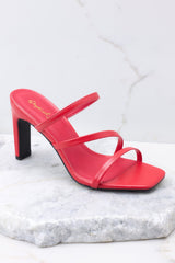 Outer-side view of these heels that feature a square toe, red insole, three straps, black soles, and a wide heel. 