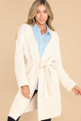 This all ivory cardigan features chunky knit fabric and a waist tie.