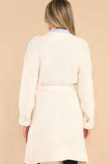 back view of this cardigan that features chunky knit fabric and a waist tie.