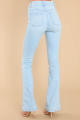 Back view of these jeans that feature flared legs, decorative front pockets, functional back pockets, and belt loops.
